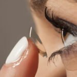 Woman inserting contact lens