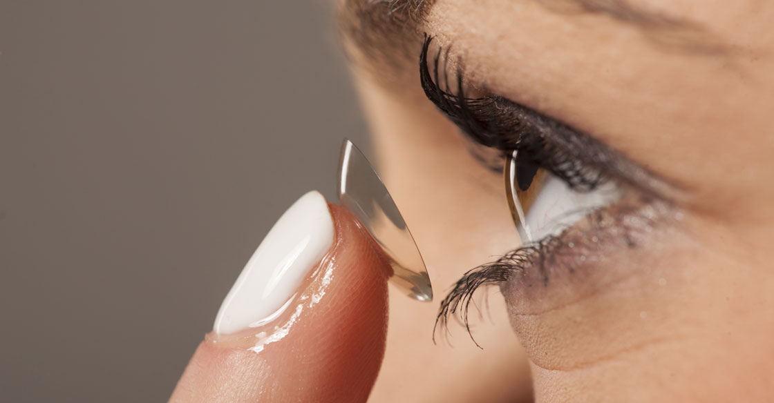 Woman inserting contact lens