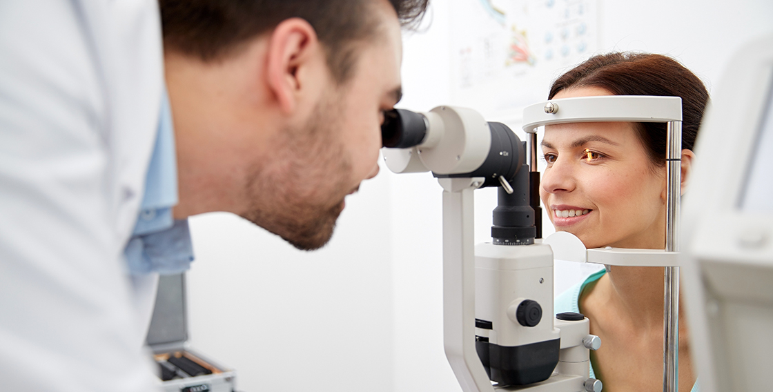 An Eye Doctor performing a slit lamp exam on a patient