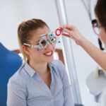 Woman doing eye test with optometrist in eye sight clinic