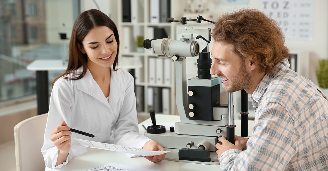 Optometrist reviewing chart with patients