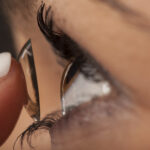 A woman putting on contact lenses