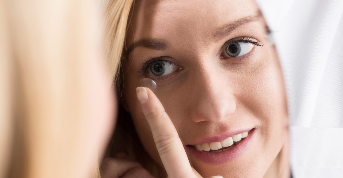 Contact lens care -Woman putting in a contact lens